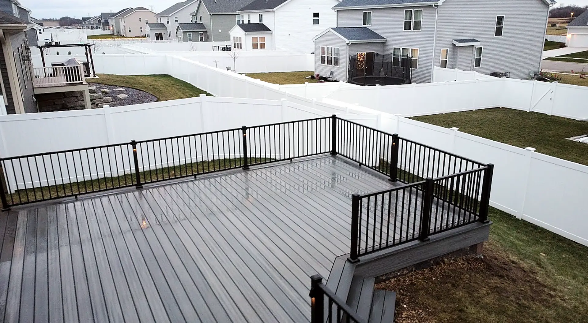 Composite deck with black metal deck railing deck accessories - Deck Railings Contractor in the greater madison area WI