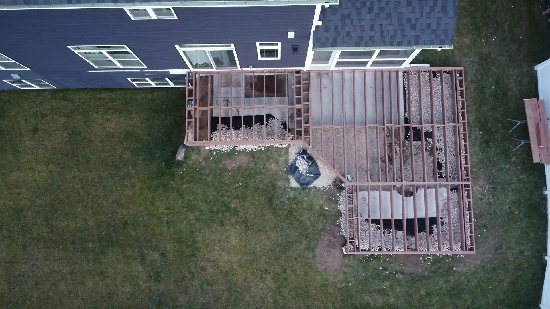 aerial view of a raised single-level composite deck framing with deck steps and deck railing - What Is Deck Framing - Deck Framing Contractors near me in Dane County WI