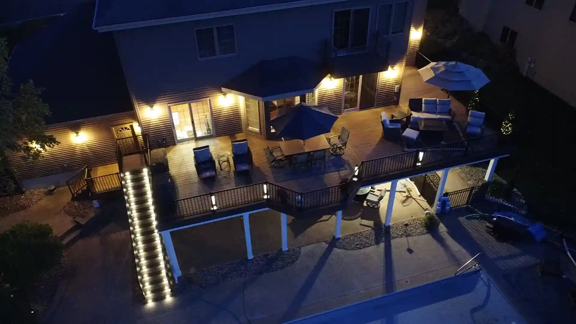 elevated deck with deck lighting installation projects, including sconce lighting, deck stair lighting, and post cap lighting, and string lighting