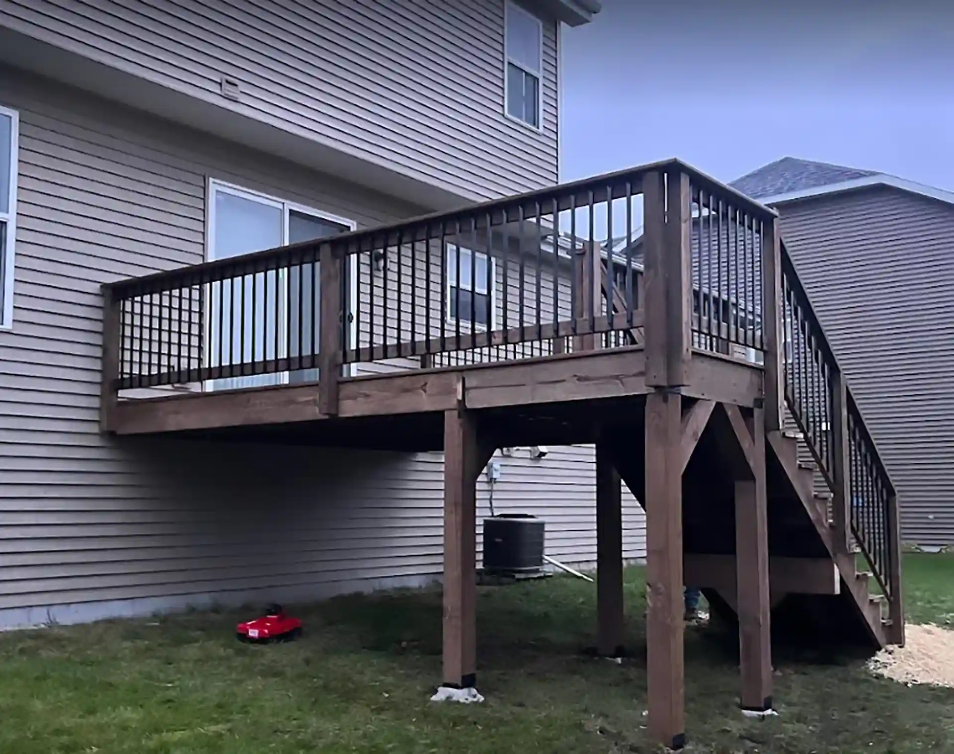Photo of an older deck that is showing signs of age and in need of deck maintenance or deck replacement