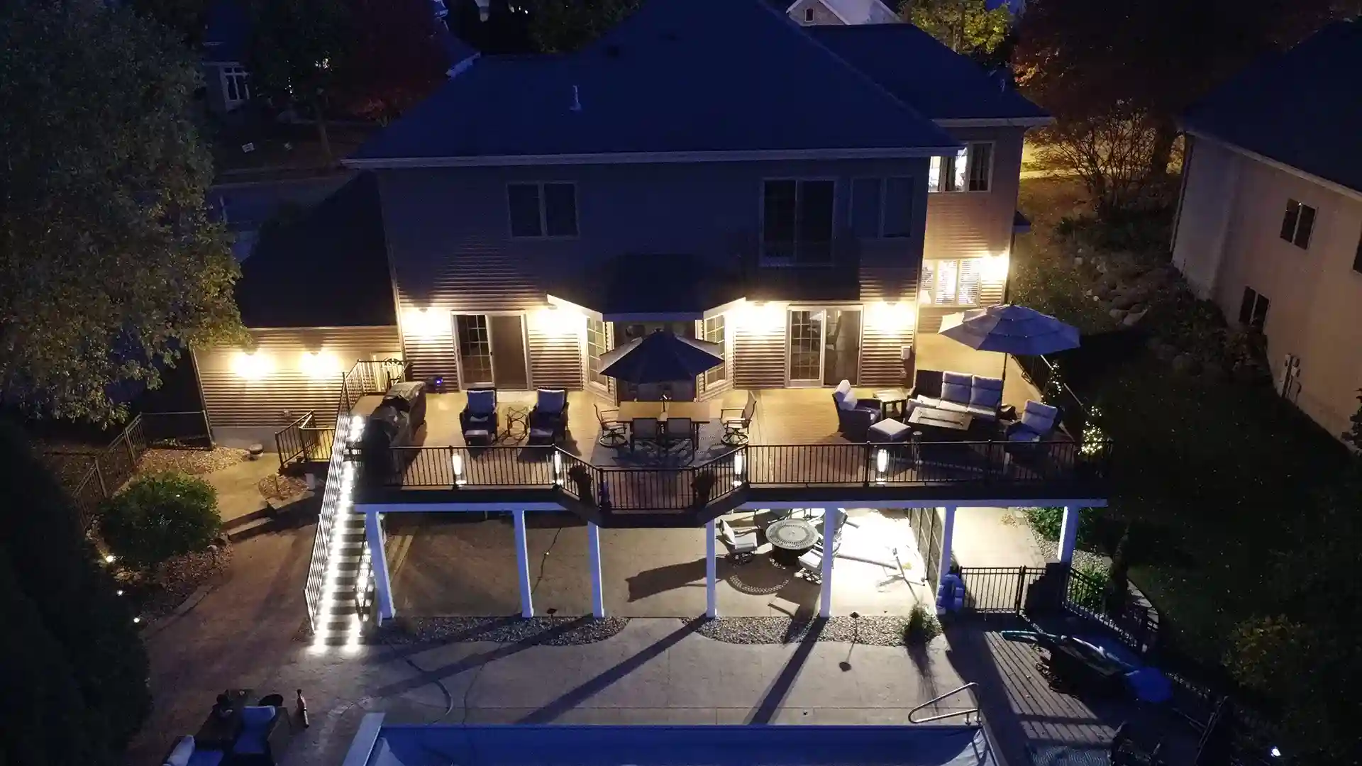 photo of an elevated deck with a dry space underneath that provides cover for an outdoor dining room.